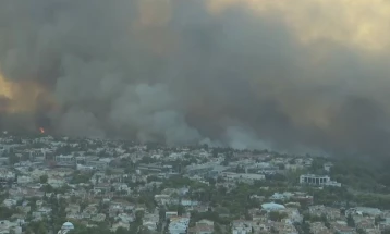 Emergency services battle huge fire raging through suburban Athens