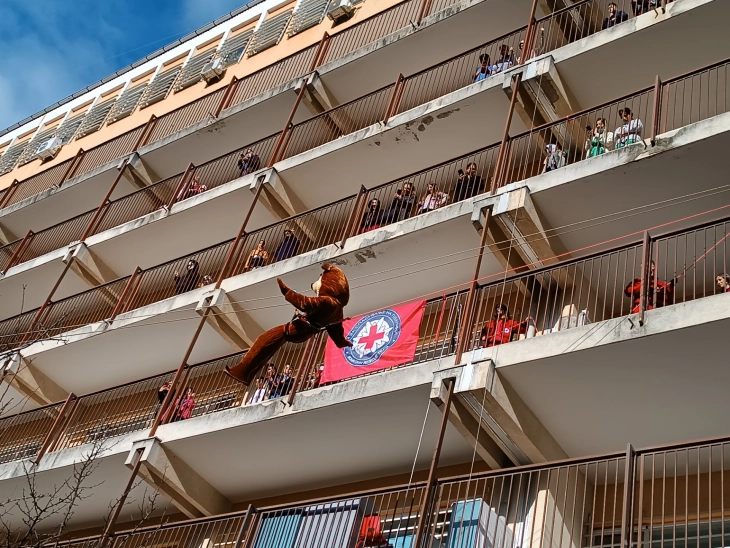 Rappelling superheroes, cartoon characters, Santa Claus light up smiles at Children's Hospital
