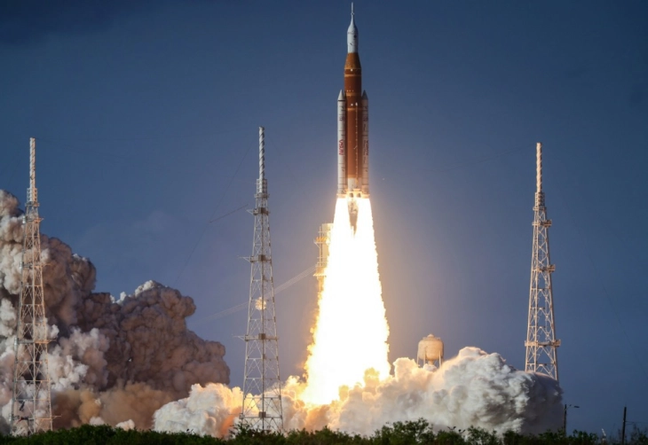 Manned mission to moon fires engines to leave Earth's orbit